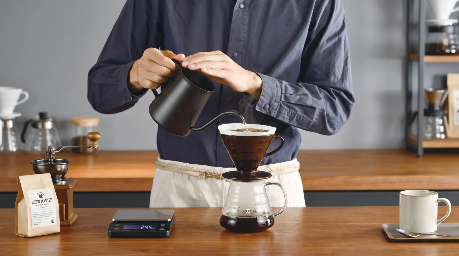 Top-down: five small pours charted in a barista's notebook beside the V60.